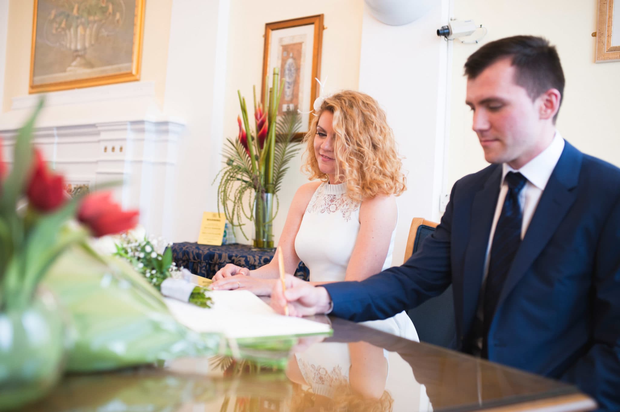 bride and groom Bromley on Bow Registry office, London UK Wedding photography ceremony room with the guest