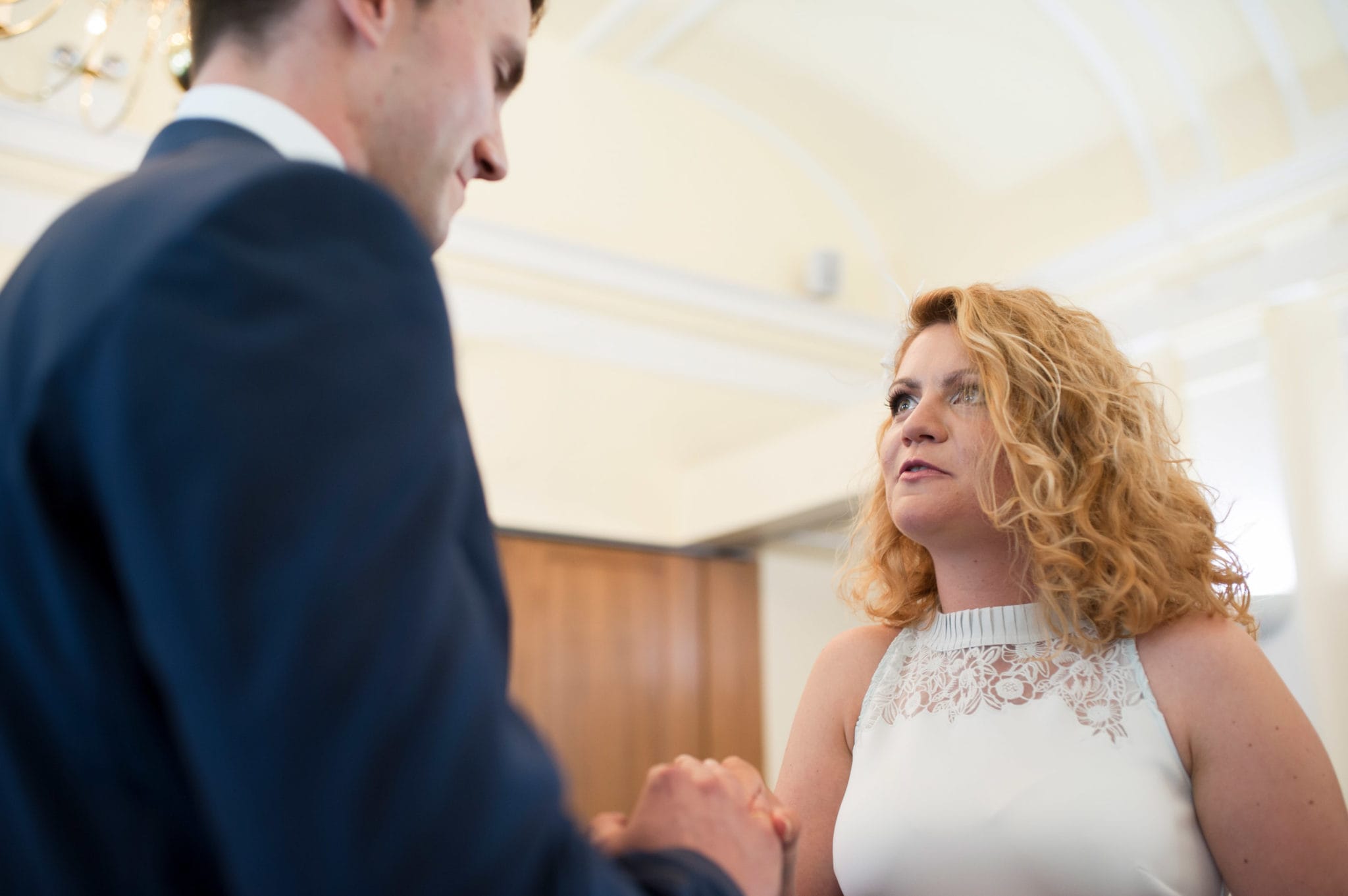 bride and groom Bromley on Bow Registry office, London UK Wedding photography ceremony room with the guest