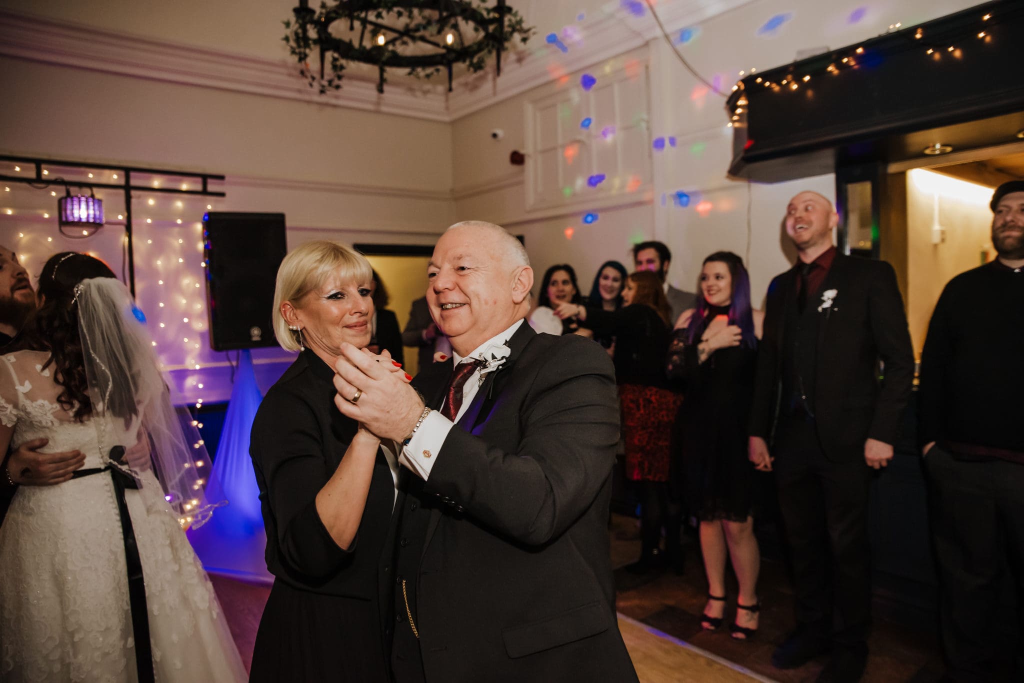 Dancing couple at the wedding reception Shenley cricket club , white wedding dress, black and red themed wedding