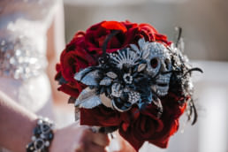 wedding bouquet , red roses, skulls black feathers, diamante , alternative design