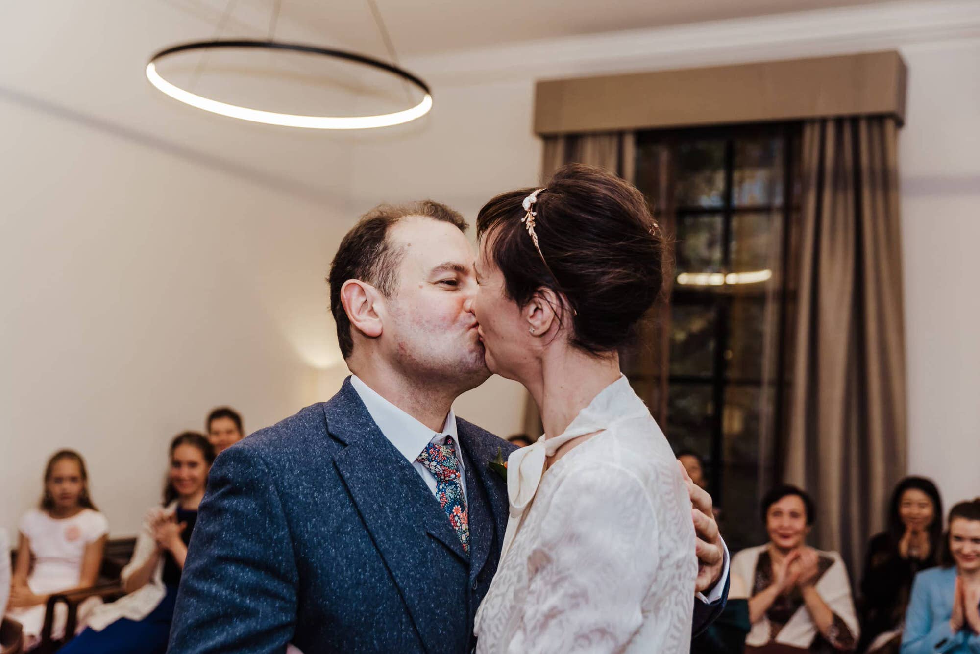 Katya in silk vintage weddign dress, Brett in blue suit at the Old Marylebone registry office london first kiss ceremony