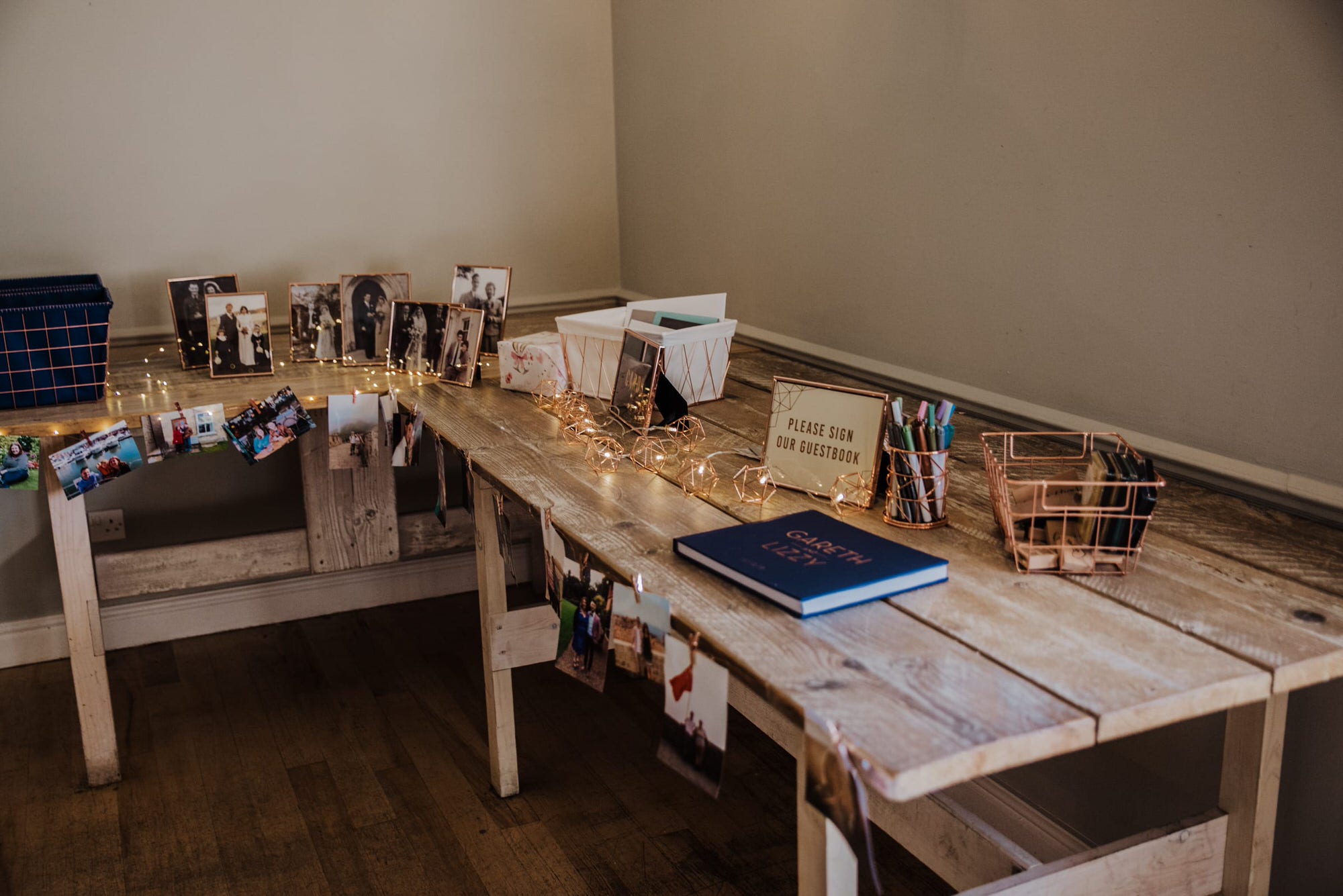 wedding guest book table with famiky photo fromaes on 3 generations and fairy lights Roshni photography The Milling Barn, Bluntswood Hall, Throcking wedding photographer