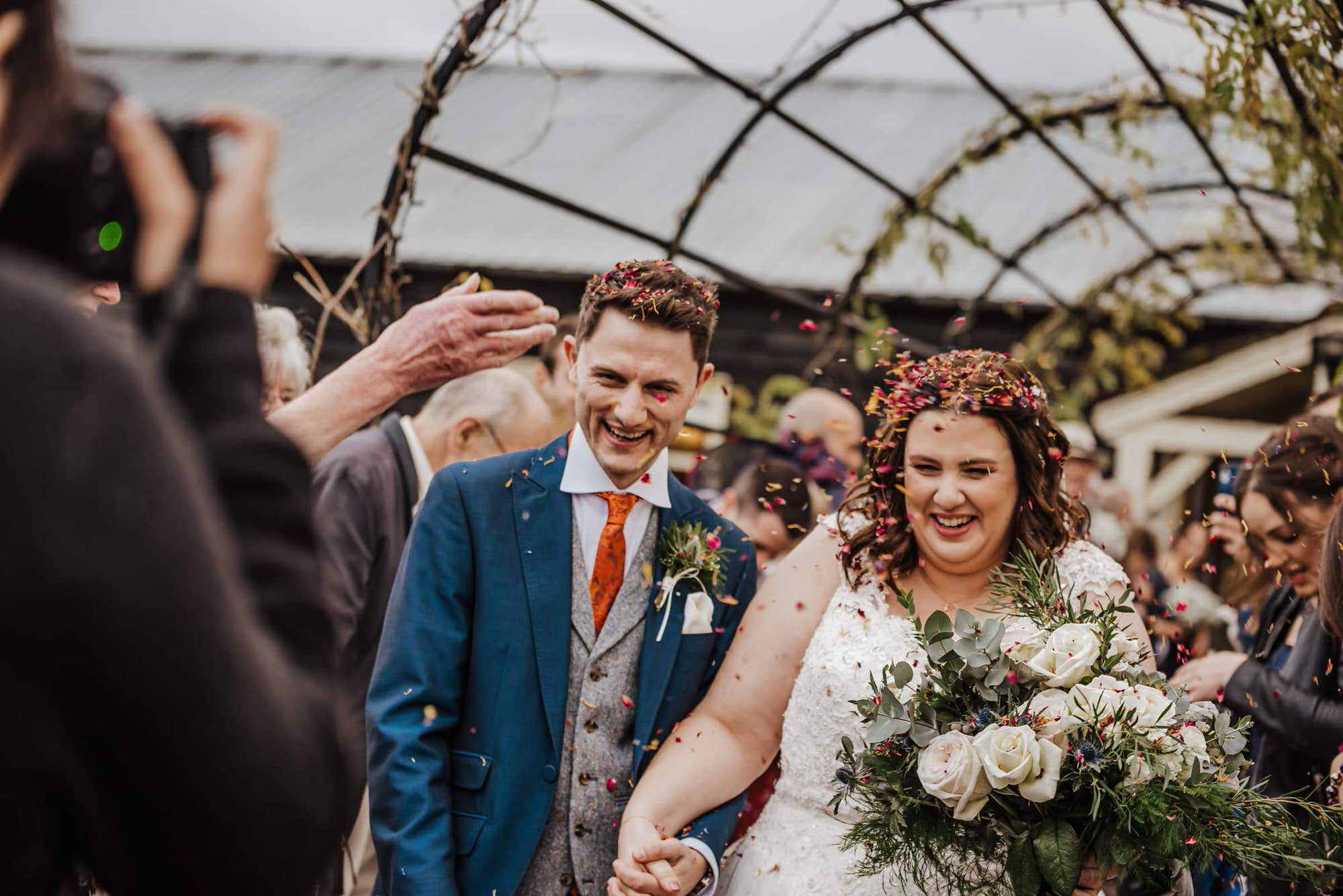 Confetti of Groom and bride after the wedding ceremony Roshni photography The Milling Barn, Bluntswood Hall, Throcking wedding photographer