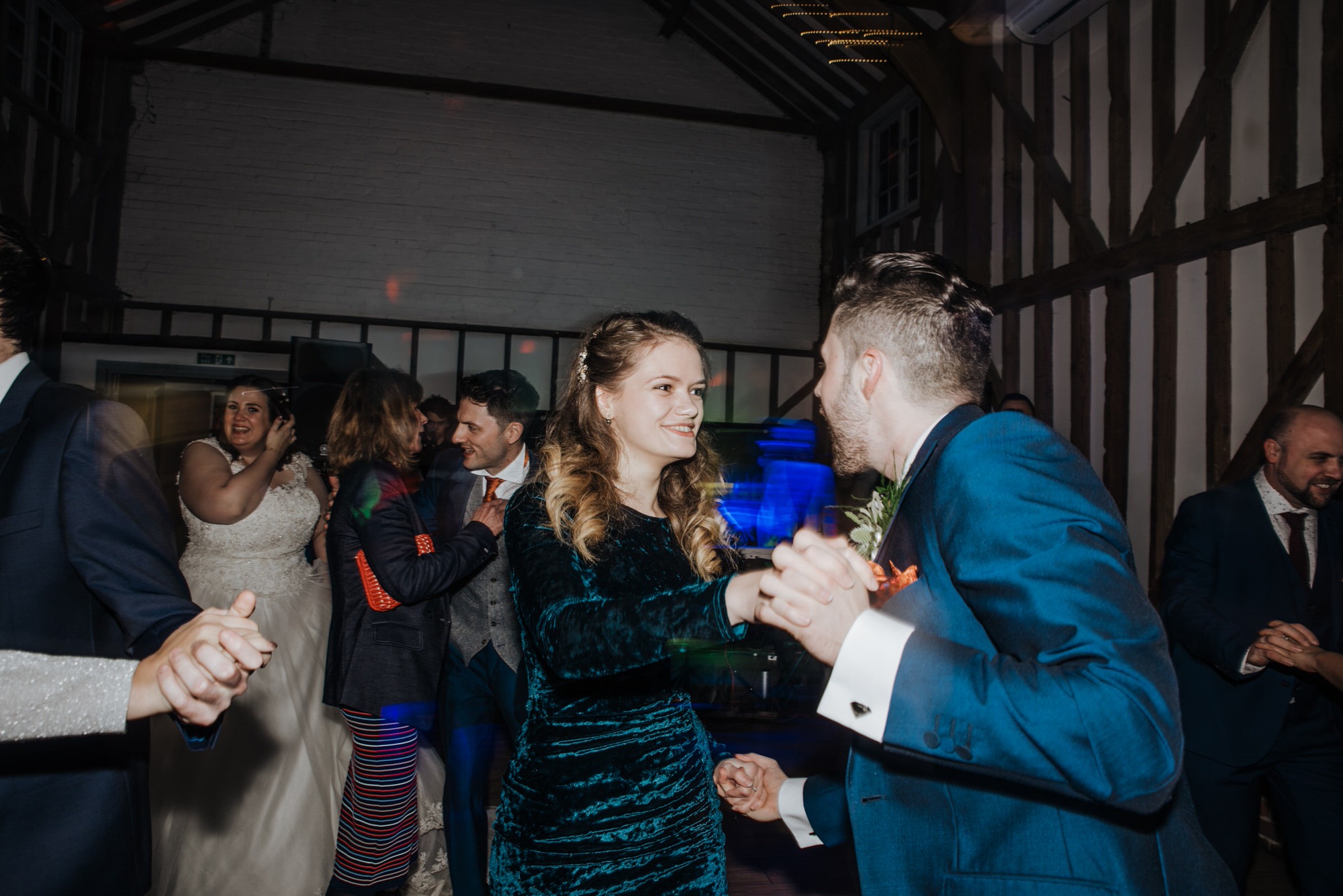 Dancing guests and bride and groom at the reception Roshni photography The Milling Barn, Bluntswood Hall, Throcking wedding photographer