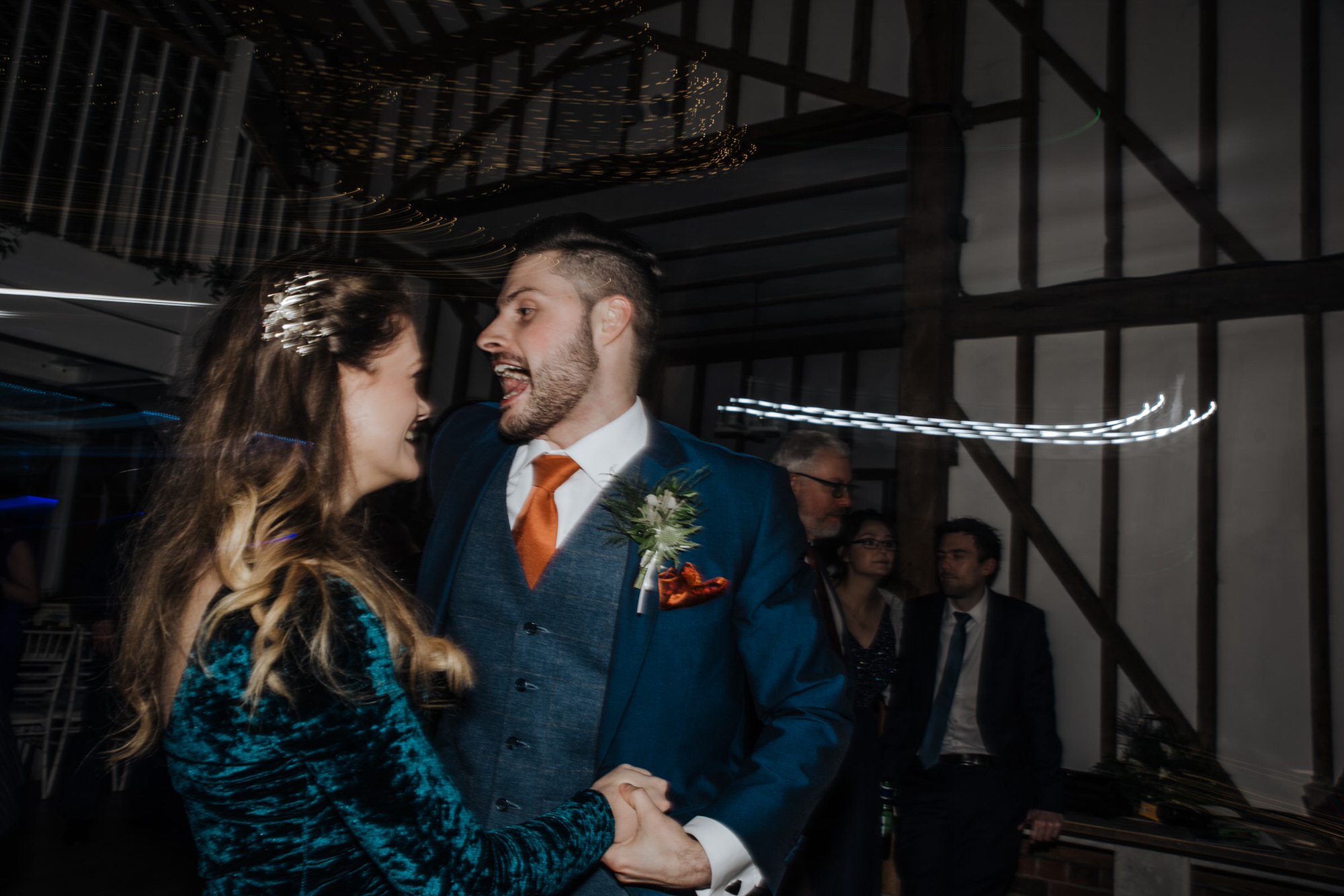 Dancing guests and bride and groom at the reception Roshni photography The Milling Barn, Bluntswood Hall, Throcking wedding photographer