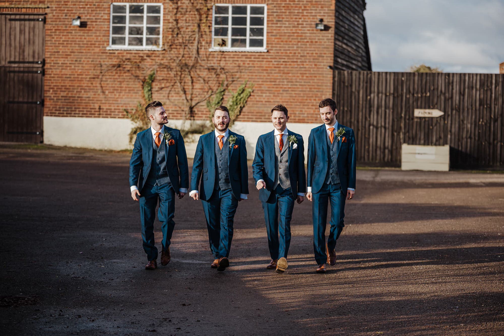 Groom and Groomsmen in blue suits outside the barn before the wedding Roshni photography The Milling Barn, Bluntswood Hall, Throcking wedding photographer