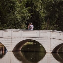 Couple at the bridge near a river at the Painshill Park Surrey engagement shoot