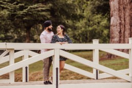 Couple near a river at the Painshill Park Surrey engagement shoot