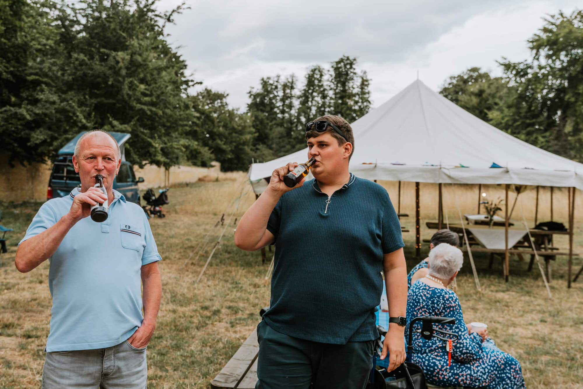 guests at the wedding drinking beer from the bottle