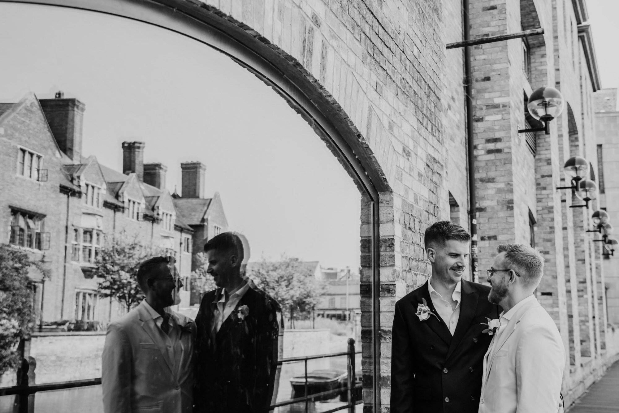 two grooms looking at each other, black and white photo
