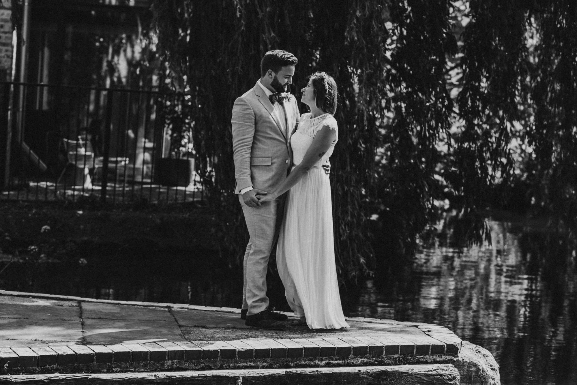 london-wedding-photographer-newlywed-couple-posing-by-lake