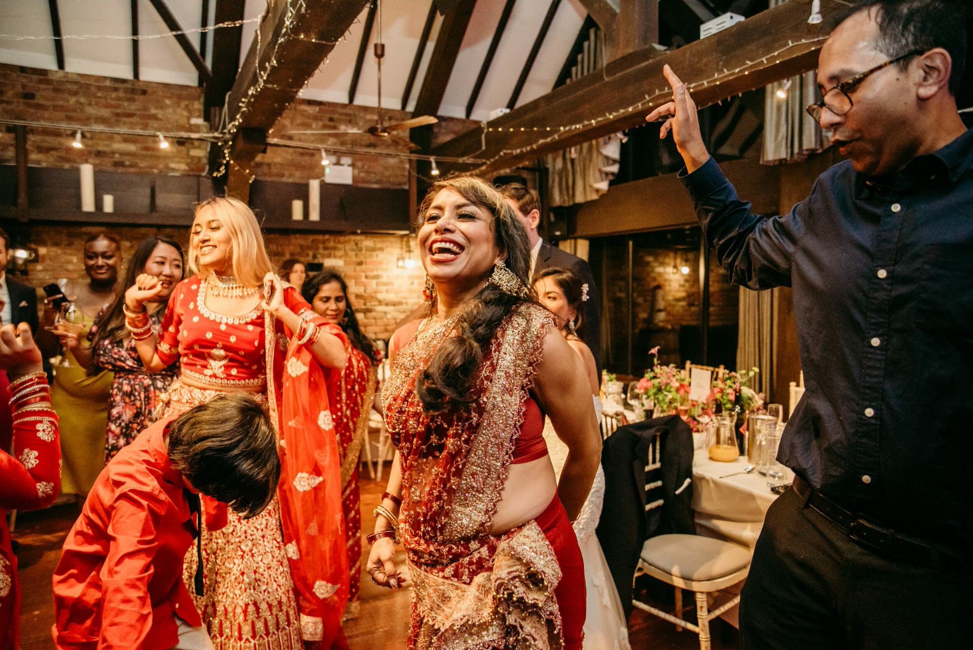 dickens-inn-tower-hill-london-london-fusion-wedding-photographer-roshni-guests dancing