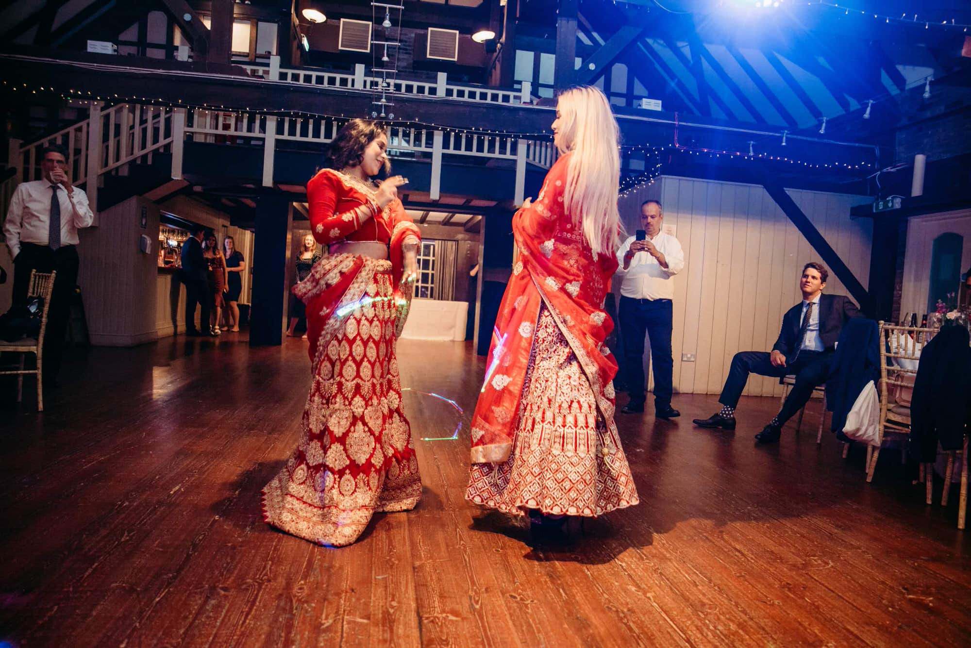 asian-wedding-london-roshni-photography-women-red-sari-dancing